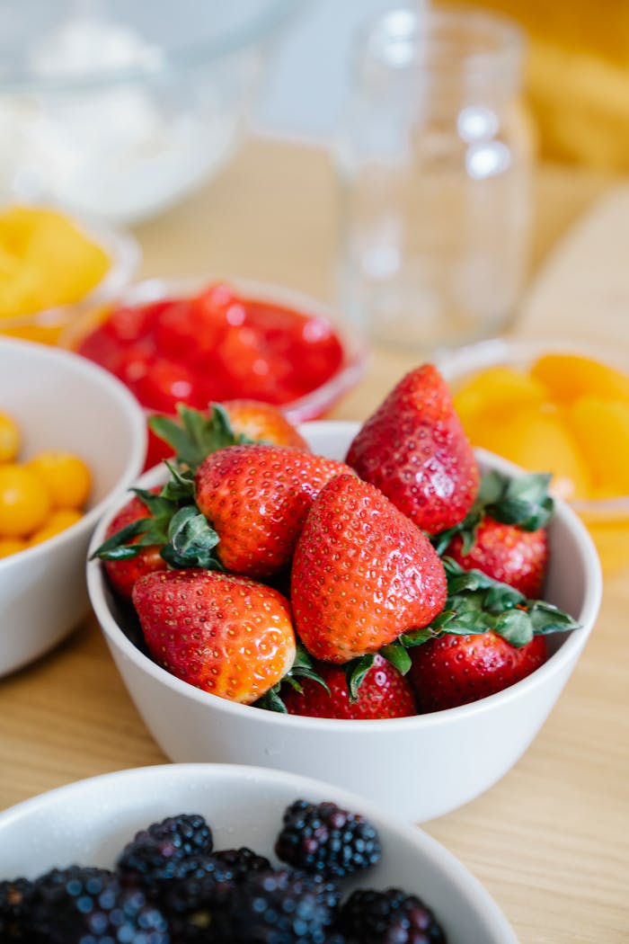 Mastering the First Impression: Your intriguing post title goes here Vibrant fresh strawberries and assorted berries in bowls, showcasing a vibrant summer fruit display.